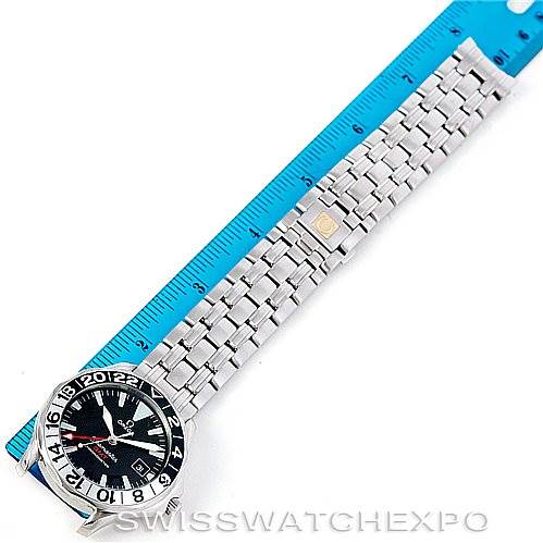 The image shows an Omega Seamaster 2234.50.00 Men
s Stainless Steel Black Dial 2234.50.00 Men
s Stainless Steel Black Dial watch laid flat, with its full metal bracelet measured against a blue ruler.