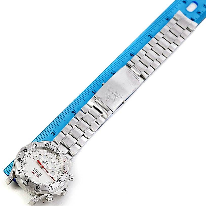 The Omega Seamaster 2595.30.00 Men
s Stainless Steel Silver Dial 2595.30.00 Men
s Stainless Steel Silver Dial watch is shown in a top-down angle, displaying the dial, bezel, bracelet, and clasp next to a blue ruler for scale.