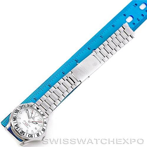 The image shows an Omega Seamaster 2538.20.00 Men
s Stainless Steel White Dial 2538.20.00 Men
s Stainless Steel White Dial watch with a silver bracelet laid next to a blue ruler, highlighting its full length.