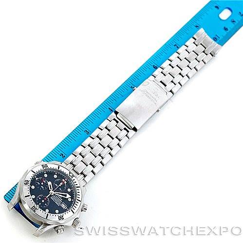 The image shows an overhead view of an Omega Seamaster 2598.80.00 Men
s Stainless Steel Blue Dial 2598.80.00 Men
s Stainless Steel Blue Dial watch, highlighting its face, bezel, and full metal bracelet next to a ruler.