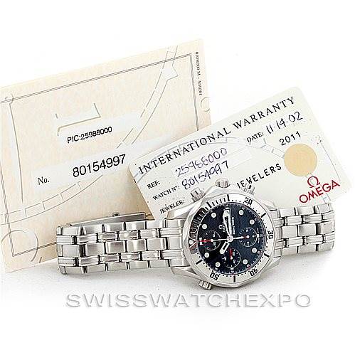 The image shows an Omega Seamaster 2598.80.00 Men
s Stainless Steel Blue Dial 2598.80.00 Men
s Stainless Steel Blue Dial watch laid flat, accompanied by an International Warranty card and other documentation.