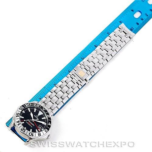 This image shows an Omega Seamaster 2234.50.00 Men
s Stainless Steel Black Dial 2234.50.00 Men
s Stainless Steel Black Dial watch laid flat beside a blue ruler, displaying the face, bezel, and metal bracelet.