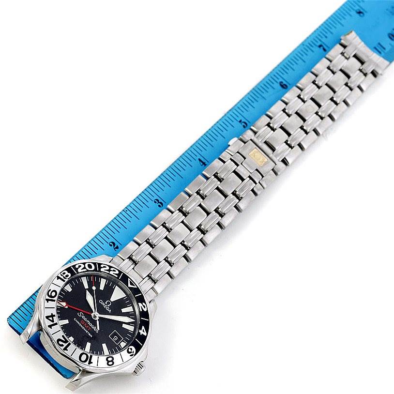 The Omega Seamaster 2234.50.00 Men
s Stainless Steel Black Dial 2234.50.00 Men
s Stainless Steel Black Dial watch is shown flat with the face and full metal bracelet displayed alongside a ruler for scale.