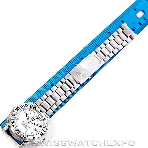 The Omega Seamaster 2538.20.00 Men
s Stainless Steel White Dial 2538.20.00 Men
s Stainless Steel White Dial watch is shown from a top-down angle, featuring its face, bezel, and bracelet next to a blue ruler for scale.