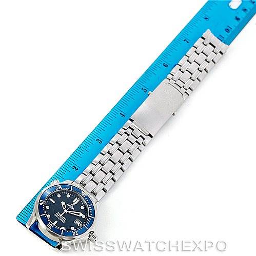 The image shows an Omega Seamaster 2561.80.00 Men
s Stainless Steel Blue Dial 2561.80.00 Men
s Stainless Steel Blue Dial watch laid flat next to a ruler, displaying the full length of its face and metal bracelet.