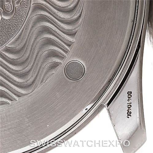 The image shows a close-up of the back case of an Omega Seamaster 2455.80.00 Men's Stainless Steel Blue Dial 2455.80.00 Men's Stainless Steel Blue Dial watch, highlighting the wavy design and engravings.