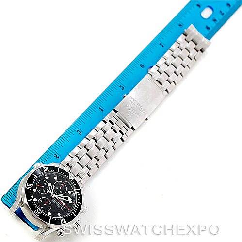 The Omega Seamaster 213.30.42.40.01.001 Men
s Stainless Steel Black Dial 213.30.42.40.01.001 Men
s Stainless Steel Black Dial watch is shown laid flat with its face and metal bracelet visible, alongside a blue ruler for scale.