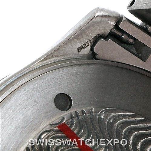 The image shows a close-up of the caseback and part of the crown of an Omega Seamaster 2031.50.00 Men
s Titanium Black Dial 2031.50.00 Men
s Titanium Black Dial watch, highlighting its detailed engraving and metal construction.