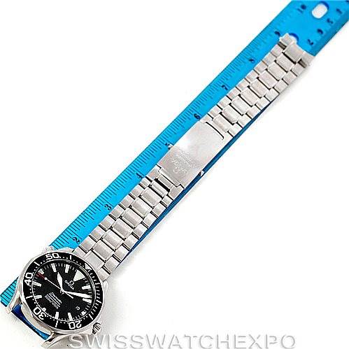 This image shows an overhead view of an Omega Seamaster 2254.50.00 Men
s Stainless Steel Black Dial 2254.50.00 Men
s Stainless Steel Black Dial watch with its metal bracelet placed alongside a blue ruler.