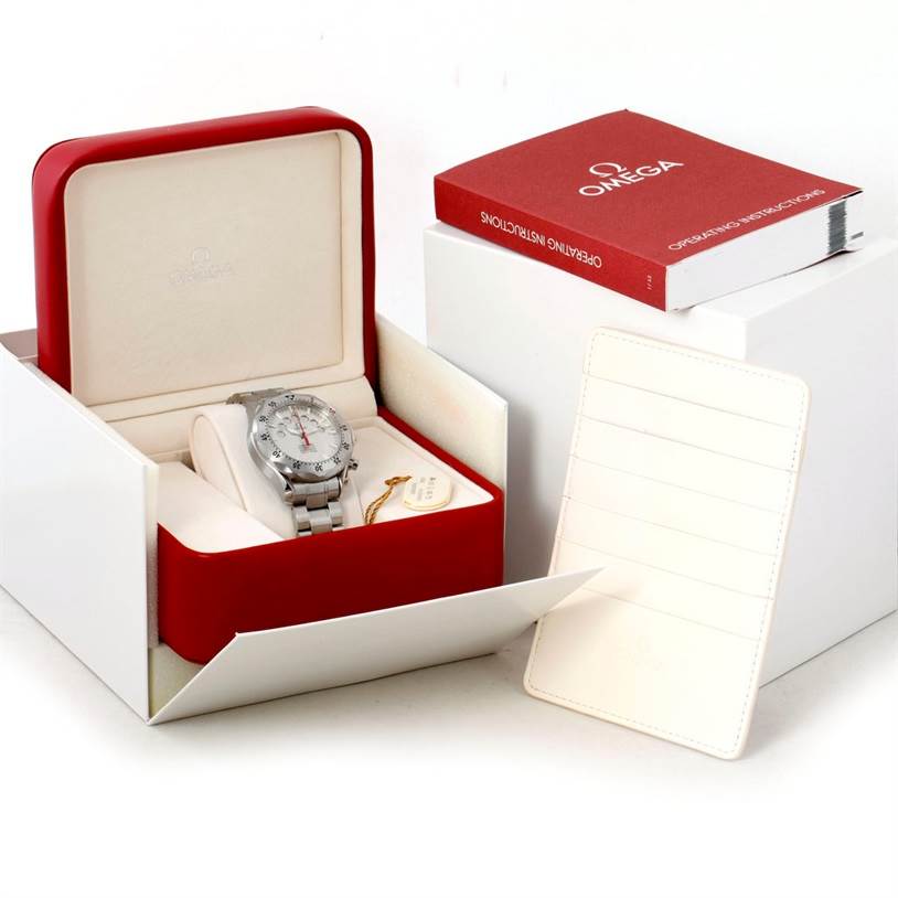 This image showcases an Omega Seamaster 2595.30.00 Men
s Stainless Steel Silver Dial 2595.30.00 Men
s Stainless Steel Silver Dial watch in its open box with an instruction manual and a cardholder nearby.