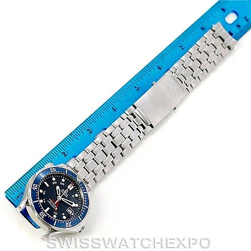 This image shows an Omega Seamaster 2535.80.00 Men
s Stainless Steel Blue Dial 2535.80.00 Men
s Stainless Steel Blue Dial watch laid flat next to a blue ruler, displaying the watch face and the stainless steel bracelet.