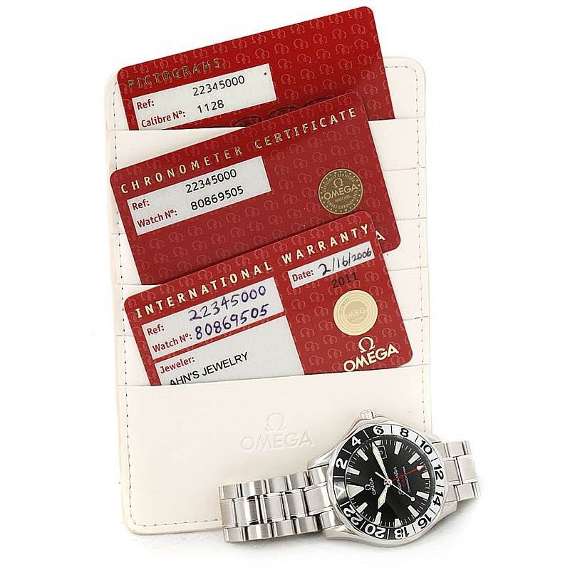 The image shows an Omega Seamaster 2234.50.00 Men
s Stainless Steel Black Dial 2234.50.00 Men
s Stainless Steel Black Dial watch along with an international warranty card, chronometer certificate, and pictogram card.