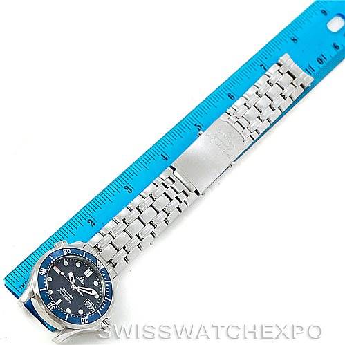 The image shows an Omega Seamaster 2561.80.00 Men
s Stainless Steel Blue Dial 2561.80.00 Men
s Stainless Steel Blue Dial watch laid flat next to a blue ruler, displaying the watch face and metal bracelet.