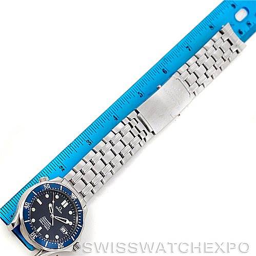 This image shows an Omega Seamaster 2531.80.00 Men
s Stainless Steel Blue Dial 2531.80.00 Men
s Stainless Steel Blue Dial watch laid flat, displaying the face, bezel, bracelet, and clasp next to a blue ruler.