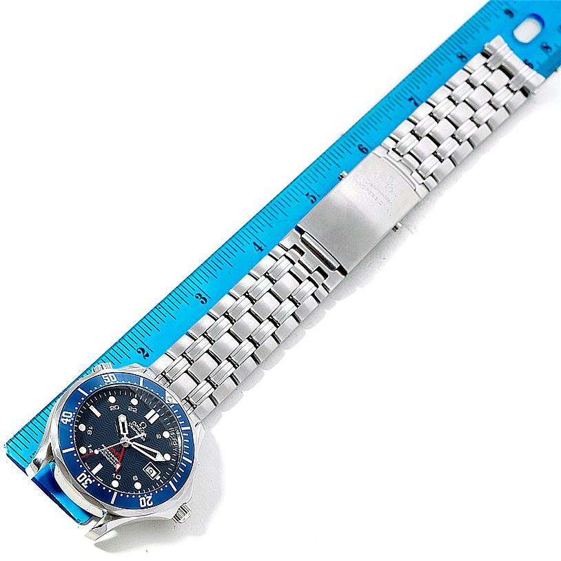 The Omega Seamaster 2535.80.00 Men
s Stainless Steel Blue Dial 2535.80.00 Men
s Stainless Steel Blue Dial watch is shown diagonally with a blue bezel, stainless steel bracelet, clasp, and a ruler for size reference.