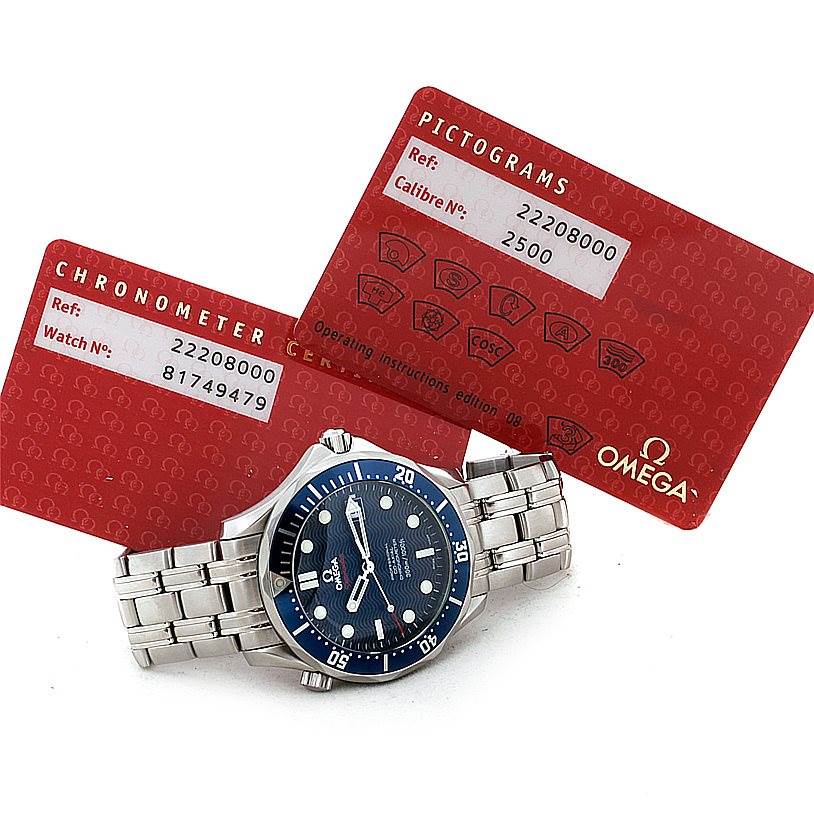 This image shows an Omega Seamaster 2220.80.00 Men
s Stainless Steel Blue Dial 2220.80.00 Men
s Stainless Steel Blue Dial watch with a stainless steel bracelet, accompanied by two red certification cards.