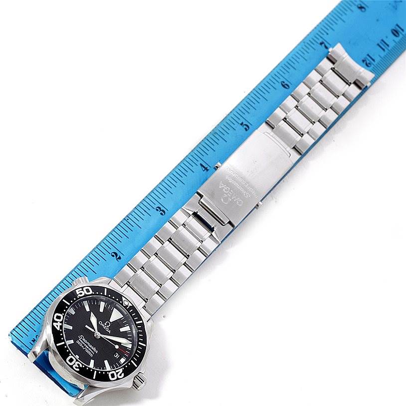 The image shows an Omega Seamaster 2262.50.00 Men
s Stainless Steel Black Dial 2262.50.00 Men
s Stainless Steel Black Dial watch laid flat with its stainless steel bracelet and clasp, next to a ruler for measurement.