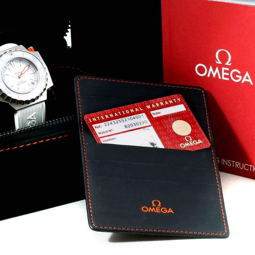 The image shows an Omega Ploprof 224.32.55.21.04.001 Men's Stainless Steel White Dial 224.32.55.21.04.001 Men's Stainless Steel White Dial watch at an angle, an international warranty card, a wallet, and the brand’s instruction manual box.