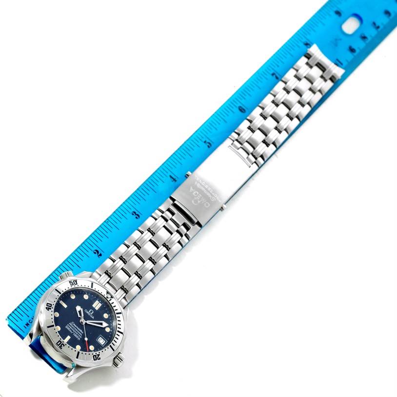 The image shows an Omega Seamaster 2552.80.00 Men
s Stainless Steel Blue Dial 2552.80.00 Men
s Stainless Steel Blue Dial watch laying flat with a metal bracelet, clasp, and ruler for measurement.