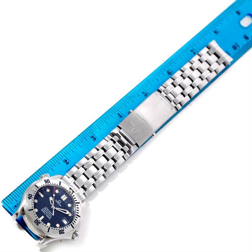 The image shows an Omega Seamaster 2552.80.00 Men
s Stainless Steel Blue Dial 2552.80.00 Men
s Stainless Steel Blue Dial watch with a metal bracelet, measured against a blue ruler.