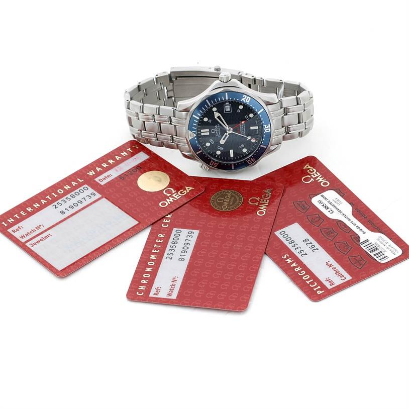 The image shows an Omega Seamaster 2535.80.00 Men's Stainless Steel Blue Dial 2535.80.00 Men's Stainless Steel Blue Dial watch with its bracelet, placed along with its warranty and certification cards.