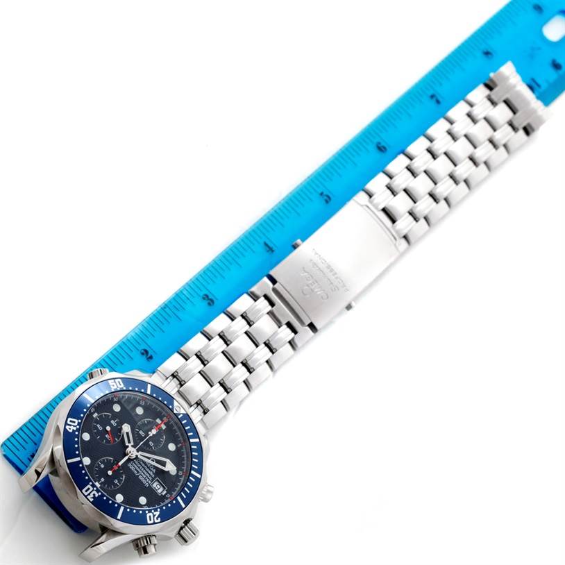 The image shows the Omega Seamaster 2599.80.00 Men
s Stainless Steel Blue Dial 2599.80.00 Men
s Stainless Steel Blue Dial watch placed next to a ruler, displaying its bracelet and clasp at a top-down angle.