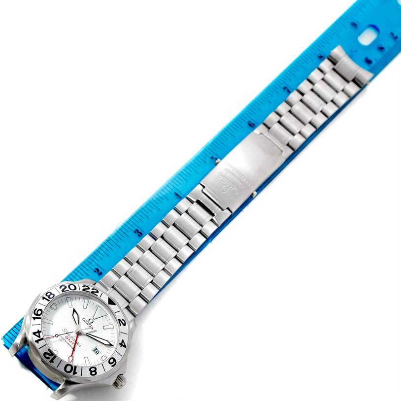 The image shows an Omega Seamaster 2538.20.00 Men
s Stainless Steel White Dial 2538.20.00 Men
s Stainless Steel White Dial watch laid flat alongside a blue ruler, displaying the watch face, bezel, and metal bracelet.