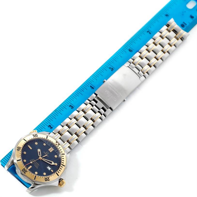 The image shows the Omega Seamaster 2342.80.00 Men
s Stainless Steel Blue Dial 2342.80.00 Men
s Stainless Steel Blue Dial watch from a top-down angle, highlighting the face, bezel, and metal bracelet beside a ruler.