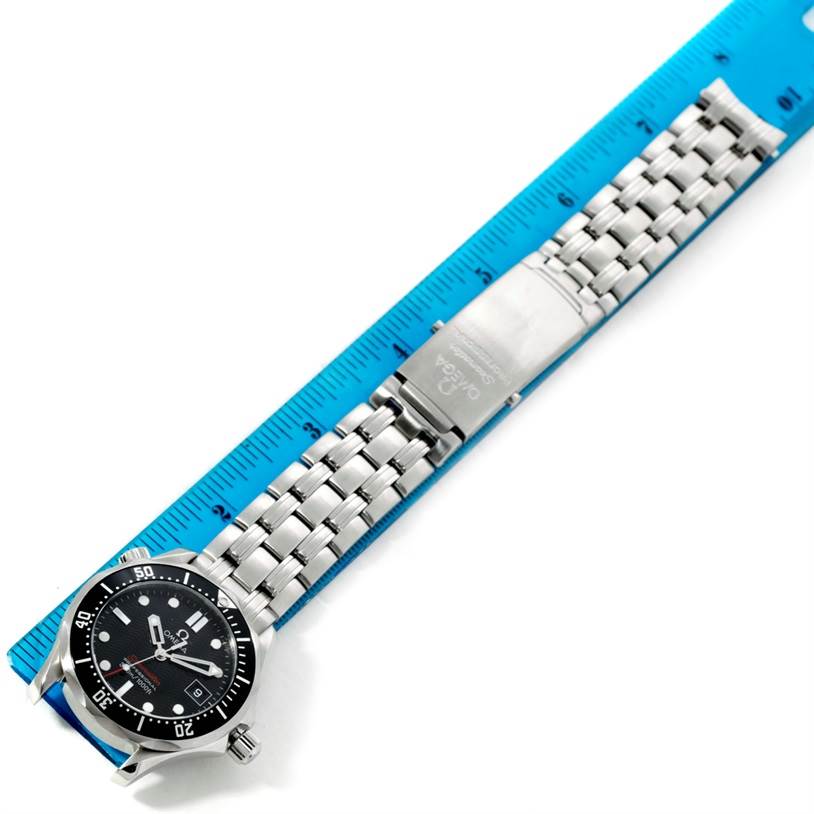 The image shows the Omega Seamaster 212.30.36.61.01.001 Men
s Stainless Steel Black Dial 212.30.36.61.01.001 Men
s Stainless Steel Black Dial watch laid flat against a blue ruler, highlighting its bracelet, clasp, and dial from a top view.