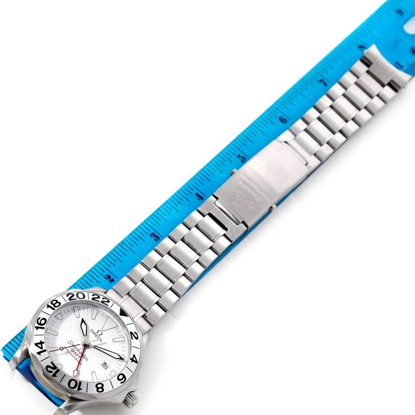 The image shows an Omega Seamaster 2538.20.00 Men
s Stainless Steel White Dial 2538.20.00 Men
s Stainless Steel White Dial watch laid alongside a blue ruler, displaying its face and metal bracelet.