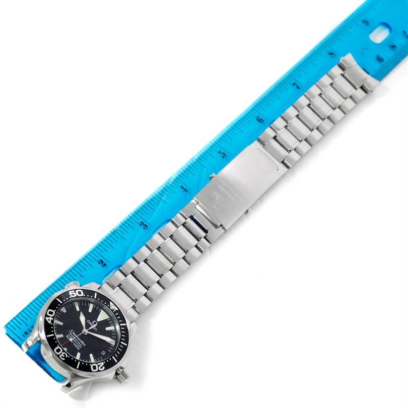 The image shows an Omega Seamaster 2252.50.00 Men
s Stainless Steel Black Dial 2252.50.00 Men
s Stainless Steel Black Dial watch and its stainless steel band, laid flat beside a ruler for measurement.