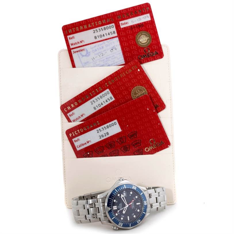 The image shows an Omega Seamaster 2535.80.00 Men
s Stainless Steel Blue Dial 2535.80.00 Men
s Stainless Steel Blue Dial watch with warranty and certification cards in the background.