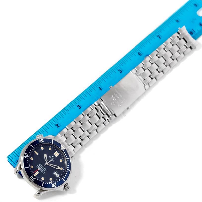 The image shows an Omega Seamaster 2531.80.00 Men's Stainless Steel Blue Dial 2531.80.00 Men's Stainless Steel Blue Dial watch laid flat with its face and metal bracelet visible, alongside a blue ruler for scale.