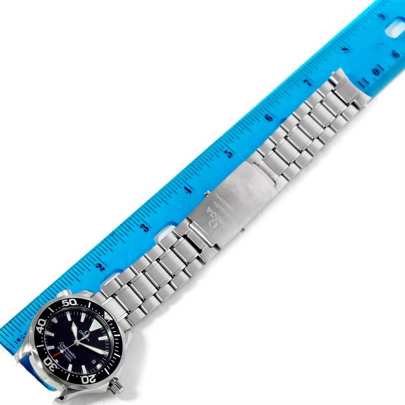 The image shows an Omega Seamaster 2262.50.00 Men's Stainless Steel Black Dial 2262.50.00 Men's Stainless Steel Black Dial watch, including its face, bezel, bracelet, and clasp, with a blue ruler for scale.