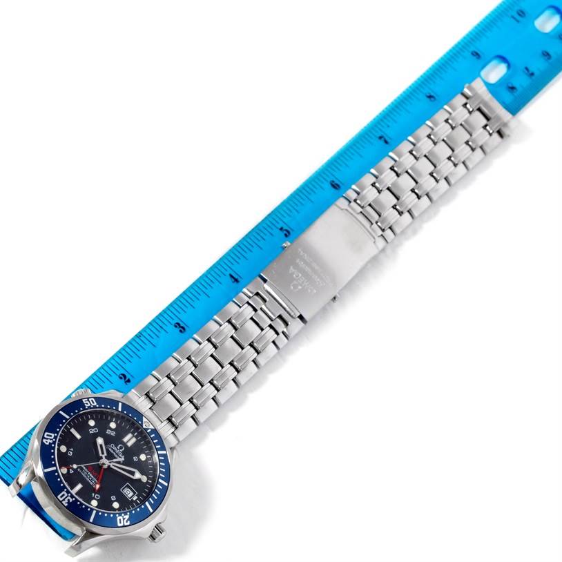 The Omega Seamaster 2535.80.00 Men's Stainless Steel Blue Dial 2535.80.00 Men's Stainless Steel Blue Dial watch is shown flat from a top-down angle, with its metal bracelet and clasp visible alongside a ruler.