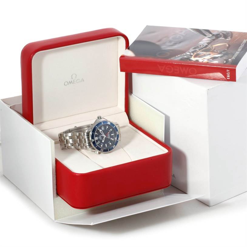 The Omega Seamaster 2535.80.00 Men's Stainless Steel Blue Dial 2535.80.00 Men's Stainless Steel Blue Dial watch is shown in a slightly angled open red box with an Omega-branded booklet beside it.