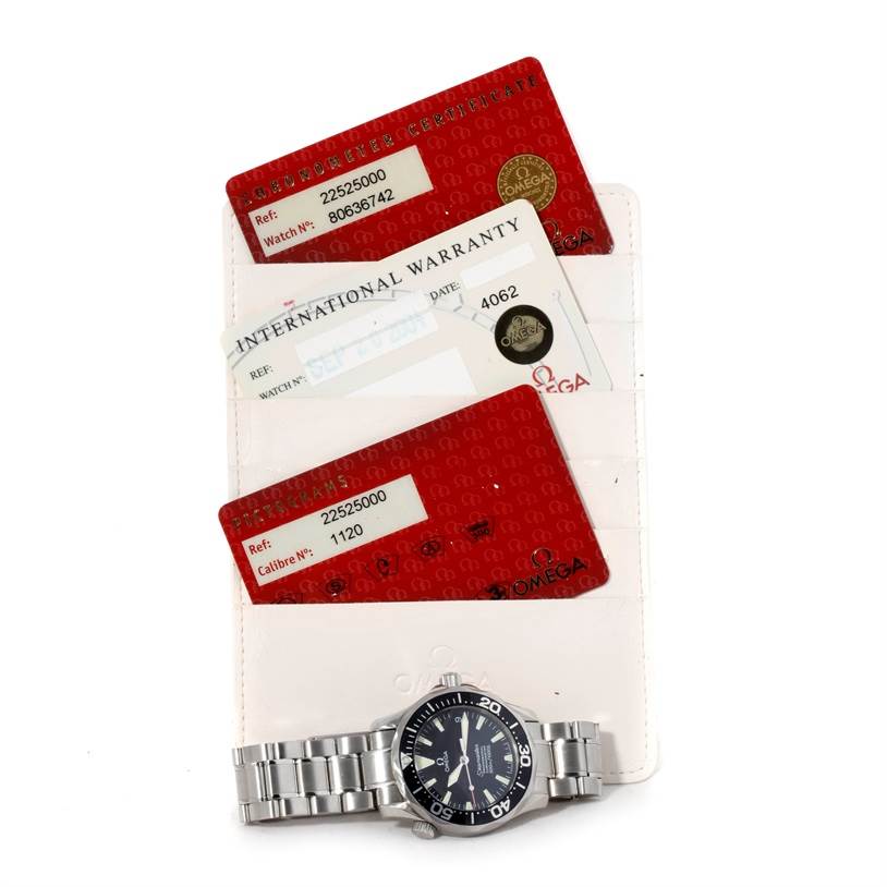 The image shows an Omega Seamaster 2252.50.00 Men
s Stainless Steel Black Dial 2252.50.00 Men
s Stainless Steel Black Dial watch along with its warranty cards and certificates, displayed from a top-down angle.