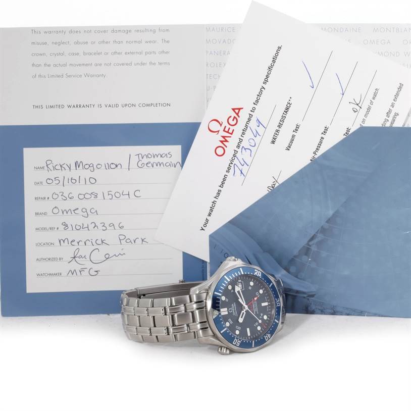 The image shows an Omega Seamaster 2535.80.00 Men's Stainless Steel Blue Dial 2535.80.00 Men's Stainless Steel Blue Dial watch displayed on its side along with warranty and service documents.