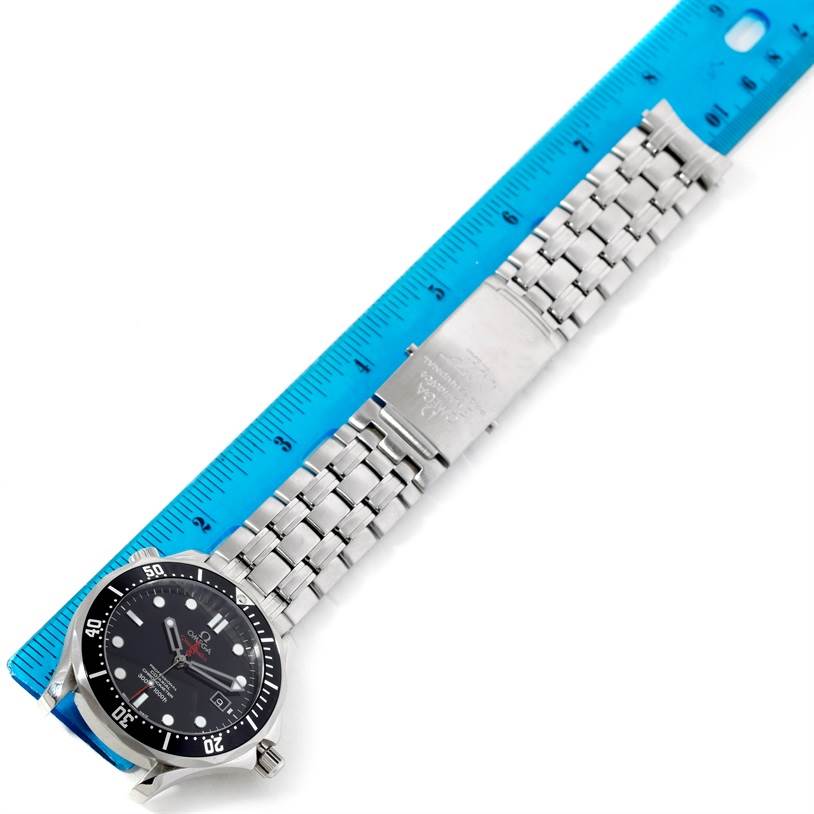 The Omega Seamaster 212.30.41.20.01.001 Men
s Stainless Steel Black Dial 212.30.41.20.01.001 Men
s Stainless Steel Black Dial watch is shown from a top-down angle, featuring its face, bezel, bracelet, and clasp next to a ruler.