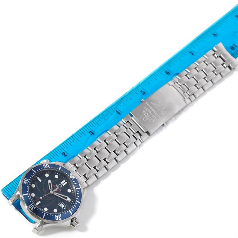 The Omega Seamaster 2226.80.00 Men
s Stainless Steel Blue Dial 2226.80.00 Men
s Stainless Steel Blue Dial watch is shown from a top angle, highlighting its blue dial and stainless steel bracelet alongside a blue ruler.