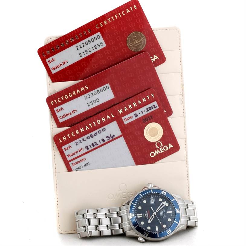 The image shows an Omega Seamaster 2220.80.00 Men's Stainless Steel Blue Dial 2220.80.00 Men's Stainless Steel Blue Dial watch with its chronometer certificate, pictograms card, and international warranty.