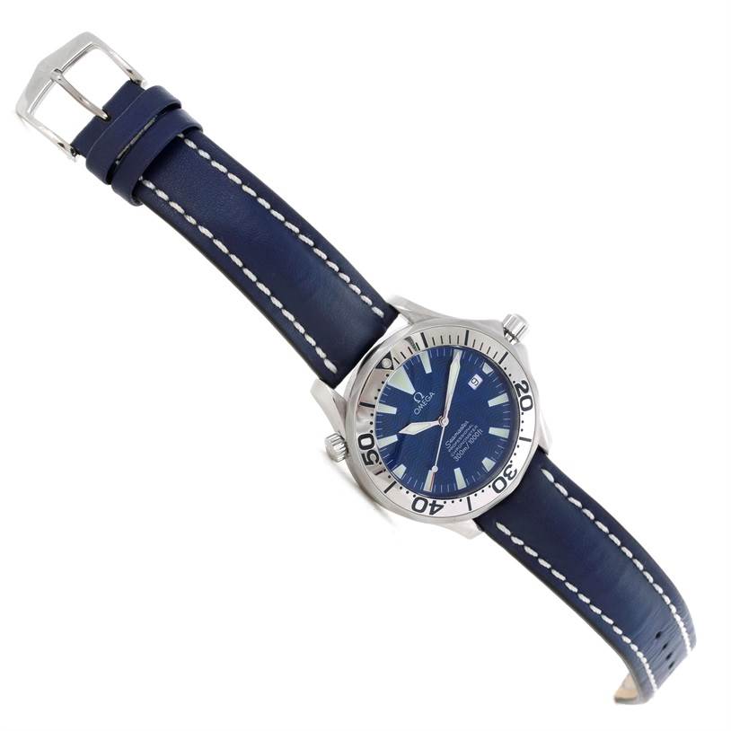 The Omega Seamaster 2255.80.00 Men's Stainless Steel Blue Dial 2255.80.00 Men's Stainless Steel Blue Dial watch is shown at an oblique angle, displaying the dial, bezel, crown, and blue leather strap with white stitching.