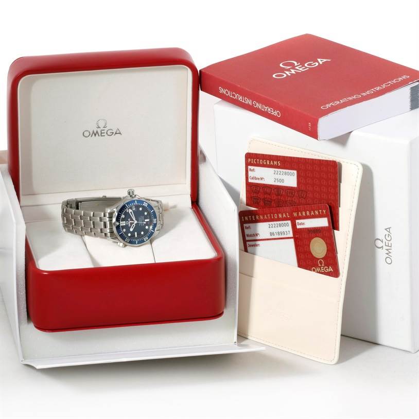The image shows an Omega Seamaster 2222.80.00 Men's Stainless Steel Blue Dial 2222.80.00 Men's Stainless Steel Blue Dial watch in its open case, along with an operating instructions book and warranty cards.