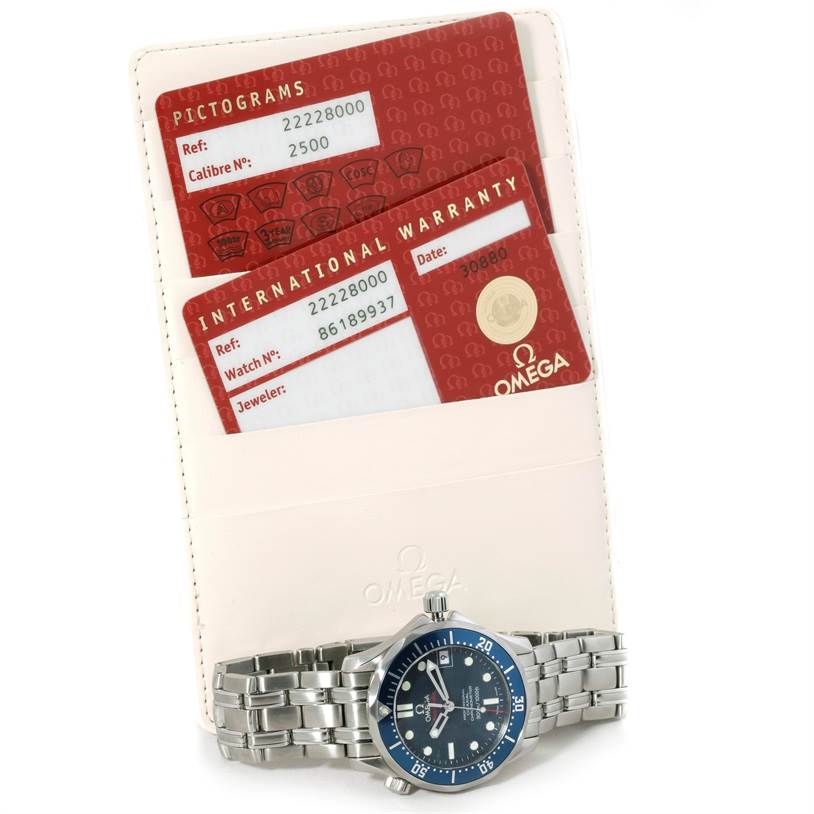 The image shows an Omega Seamaster 2222.80.00 Men's Stainless Steel Blue Dial 2222.80.00 Men's Stainless Steel Blue Dial watch and its warranty cards, with the watch lying flat and partially angled towards the camera.