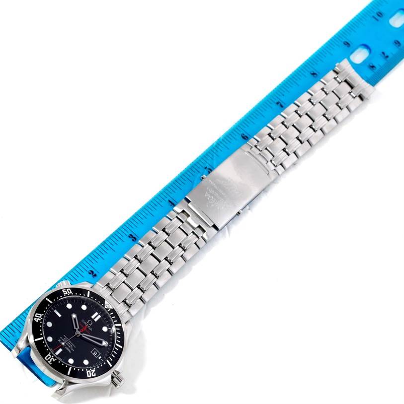 The Omega Seamaster 212.30.41.20.01.001 Men
s Stainless Steel Black Dial 212.30.41.20.01.001 Men
s Stainless Steel Black Dial watch is shown flat with its bracelet fully extended alongside a blue ruler for measurement.