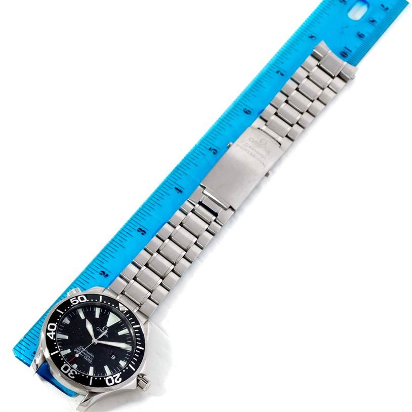 The Omega Seamaster 2264.50.00 Men's Stainless Steel Black Dial 2264.50.00 Men's Stainless Steel Black Dial watch is shown from an overhead angle, displaying its face, bracelet, and clasp adjacent to a ruler.