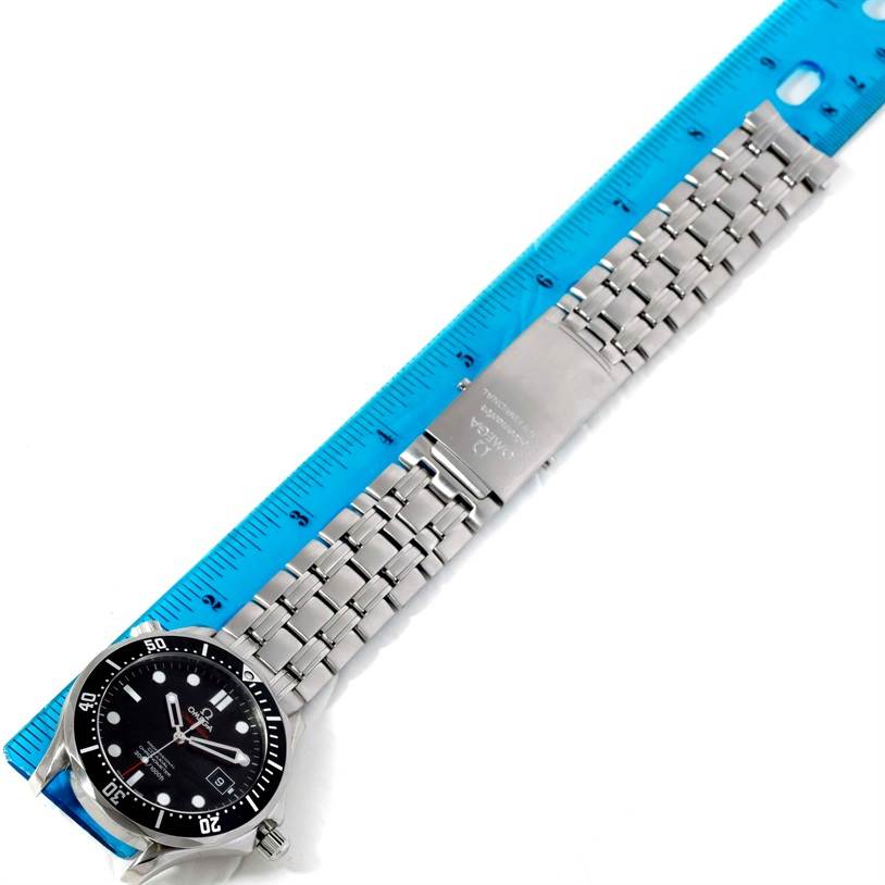 The image shows an overhead view of an Omega Seamaster 212.30.41.20.01.002 Men
s Stainless Steel Black Dial 212.30.41.20.01.002 Men
s Stainless Steel Black Dial watch with its stainless steel bracelet and clasp extended alongside a ruler.