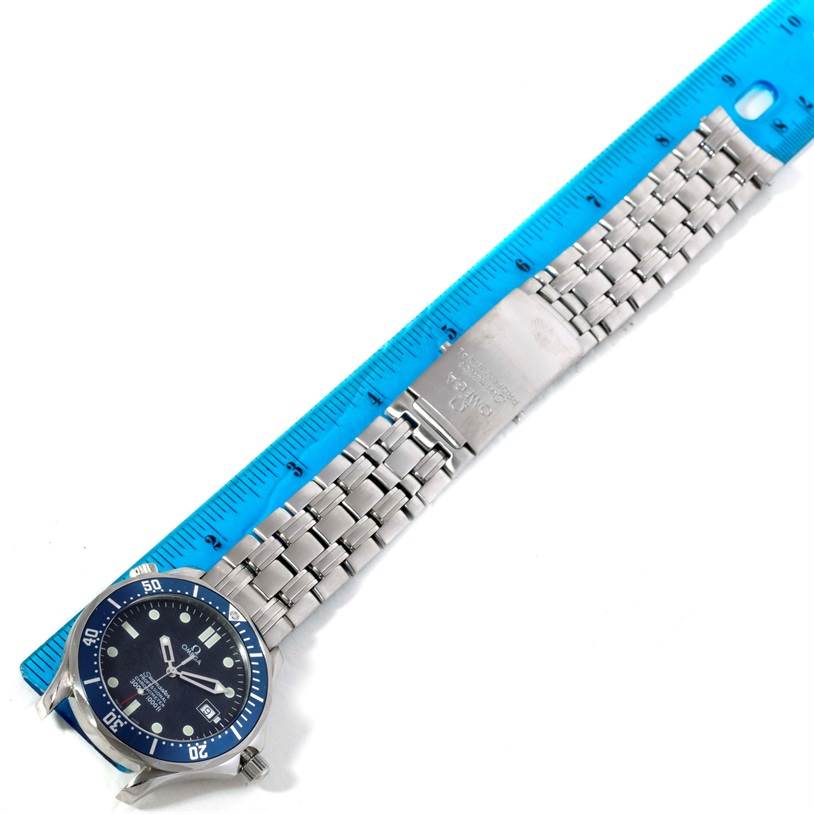 The image shows the Omega Seamaster 2531.80.00 Men
s Stainless Steel Blue Dial 2531.80.00 Men
s Stainless Steel Blue Dial watch laid flat against a ruler, displaying the face and metal bracelet.