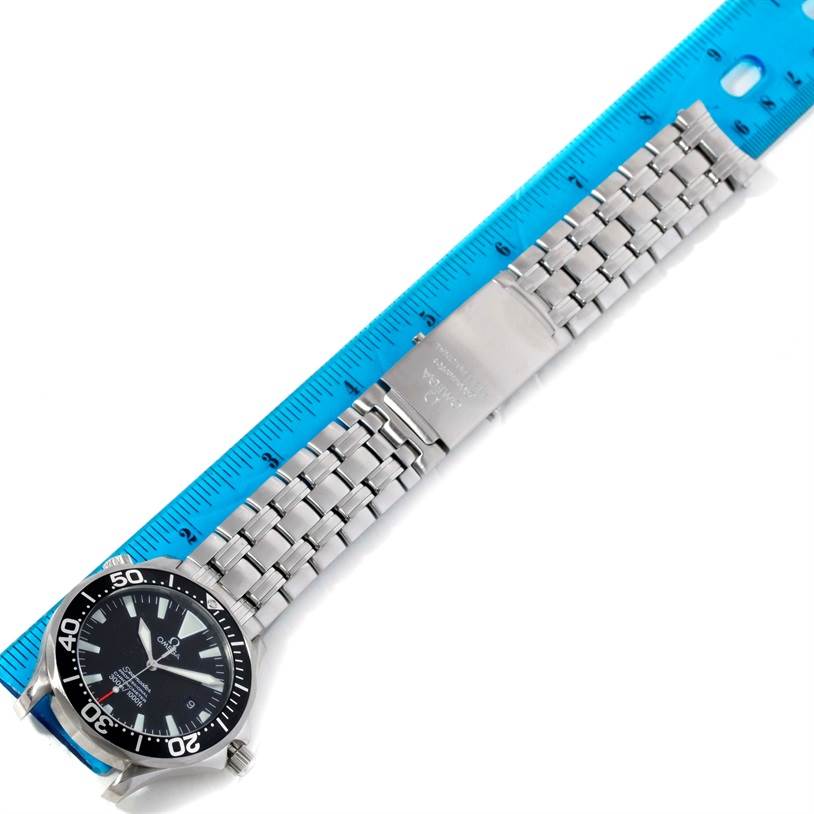 The image shows an Omega Seamaster 2254.50.00 Men
s Stainless Steel Black Dial 2254.50.00 Men
s Stainless Steel Black Dial watch laid flat with a blue ruler measuring its stainless steel bracelet.