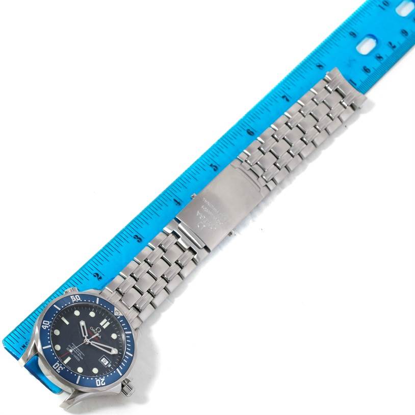 The Omega Seamaster 2220.80.00 Men
s Stainless Steel Blue Dial 2220.80.00 Men
s Stainless Steel Blue Dial watch is shown laid flat with a metal bracelet and a blue dial next to a measuring ruler.